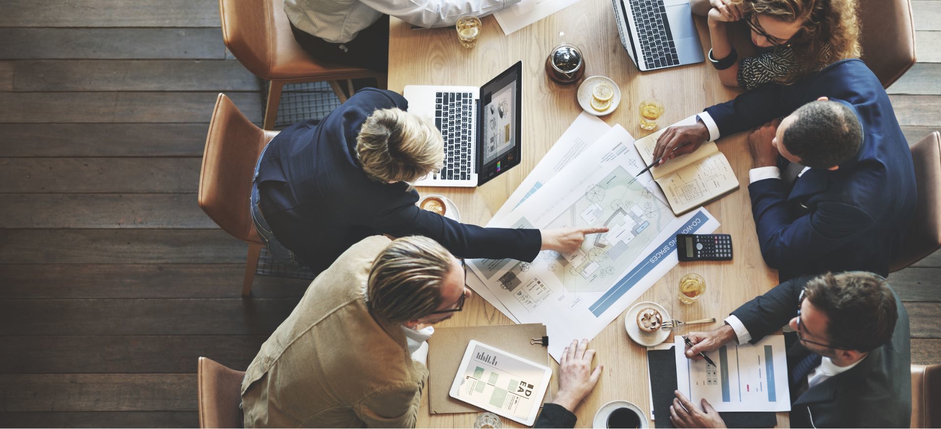 Team reviewing plans and business information around a table
